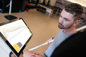 Athlete looking at training results on ipad